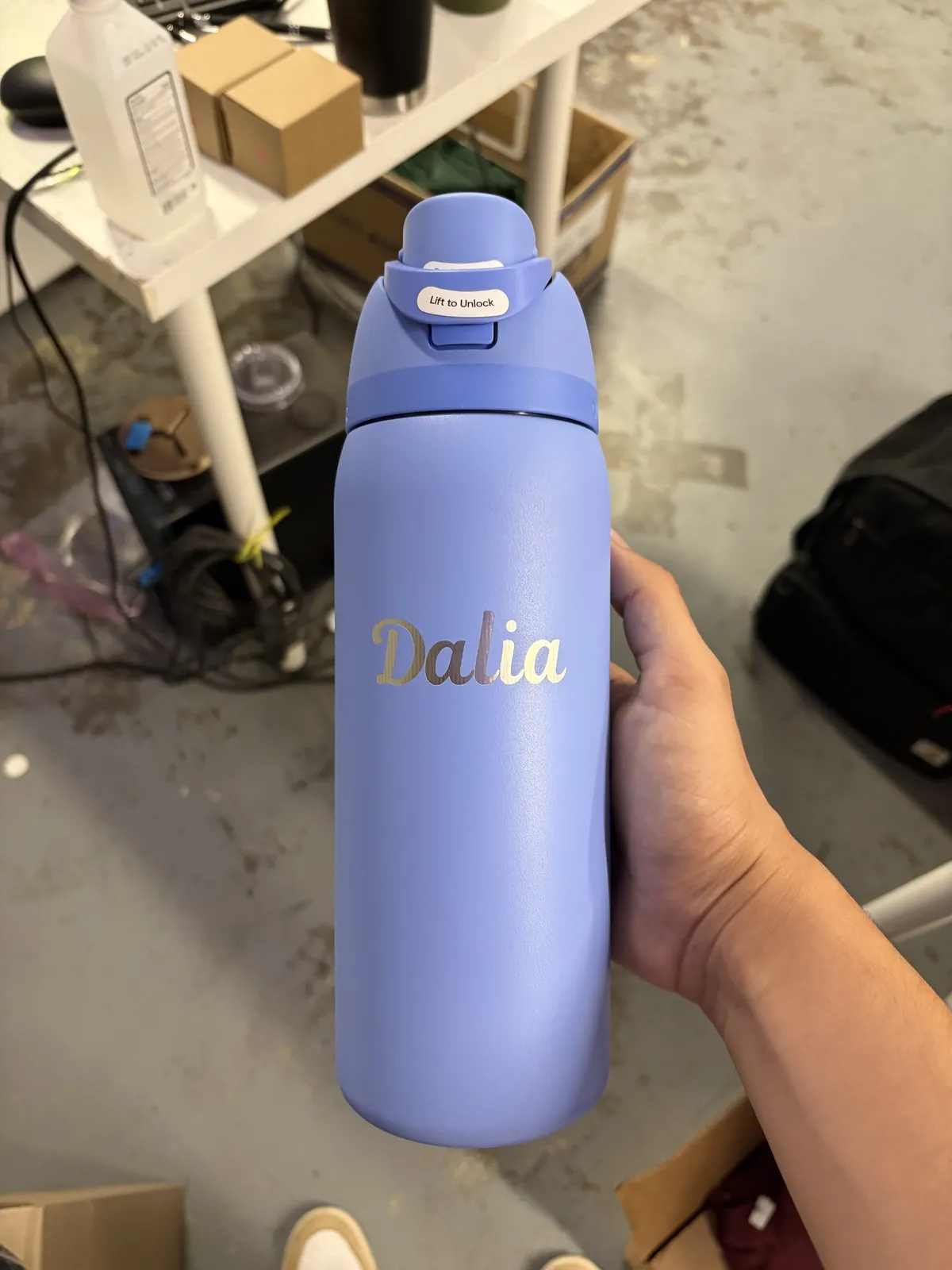 Laser-engraved tumbler held in a hand