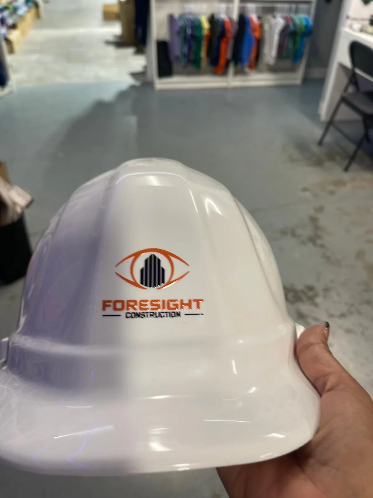 White hard hat with a die-cut logo decal