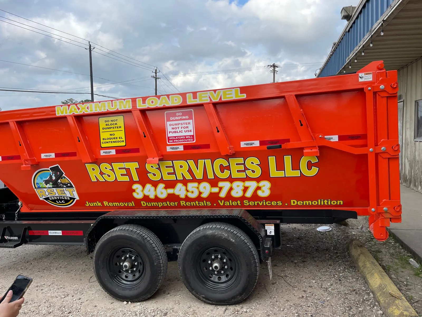 Orange dump truck with cut-vinyl company lettering